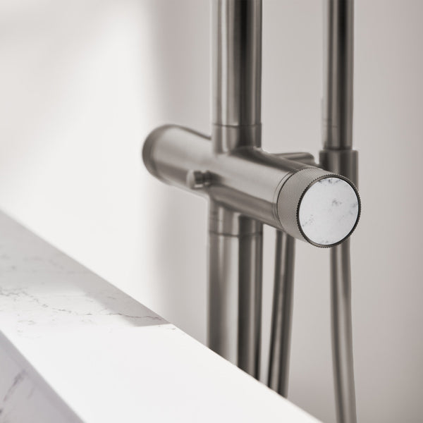 Atrio Metallic shower handle on a glass door with a blurred background